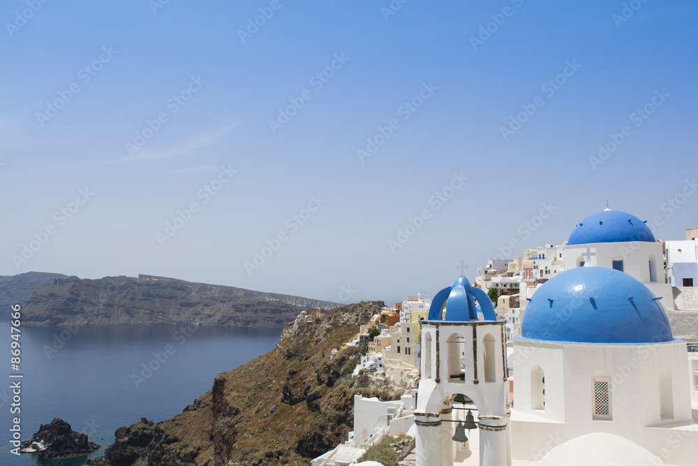 Santorini famous Orthodox church with blue domes in village Oia