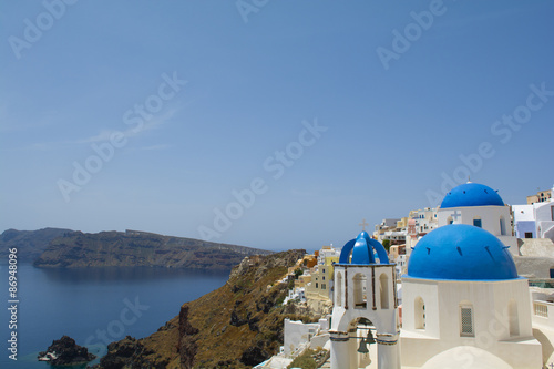 Santorini famous Orthodox church with blue domes in village Oia