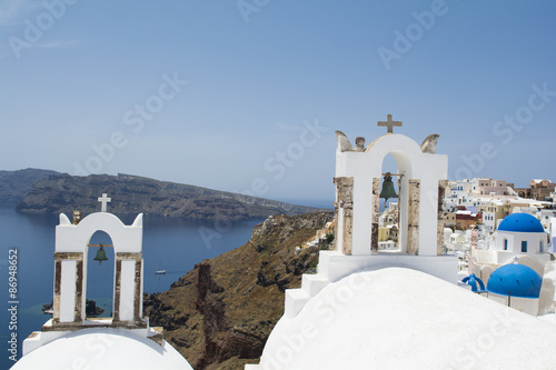 Traditional white church belfries in Oia, Santorini, Greece