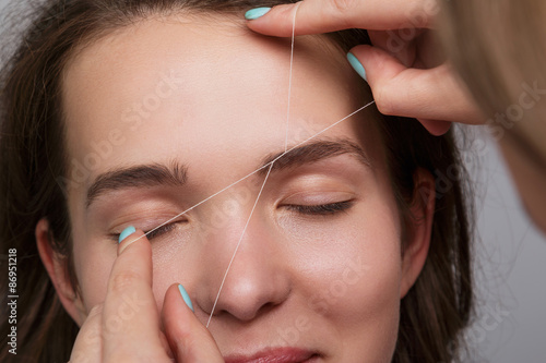 Woman during eyebrow threading