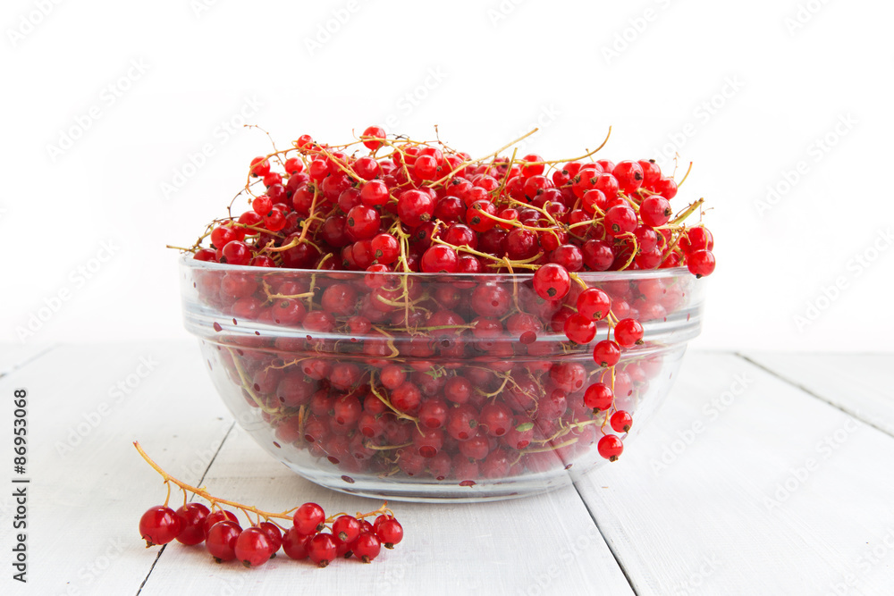 Fresh red currant on the light wooden background Fresh red currant on the light wooden background