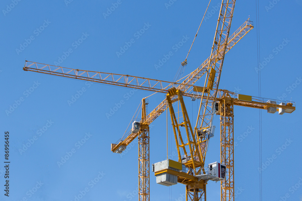 construction cranes on blue sky