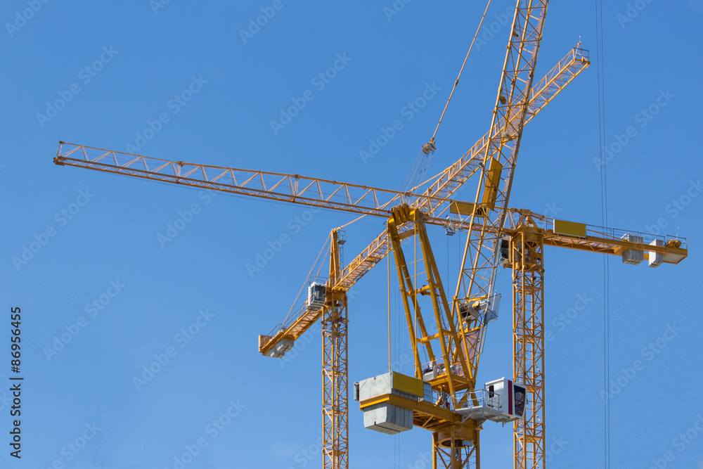 construction cranes on blue sky construction cranes on blue sky