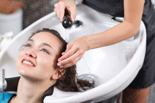 Professional hairdresser washing head 