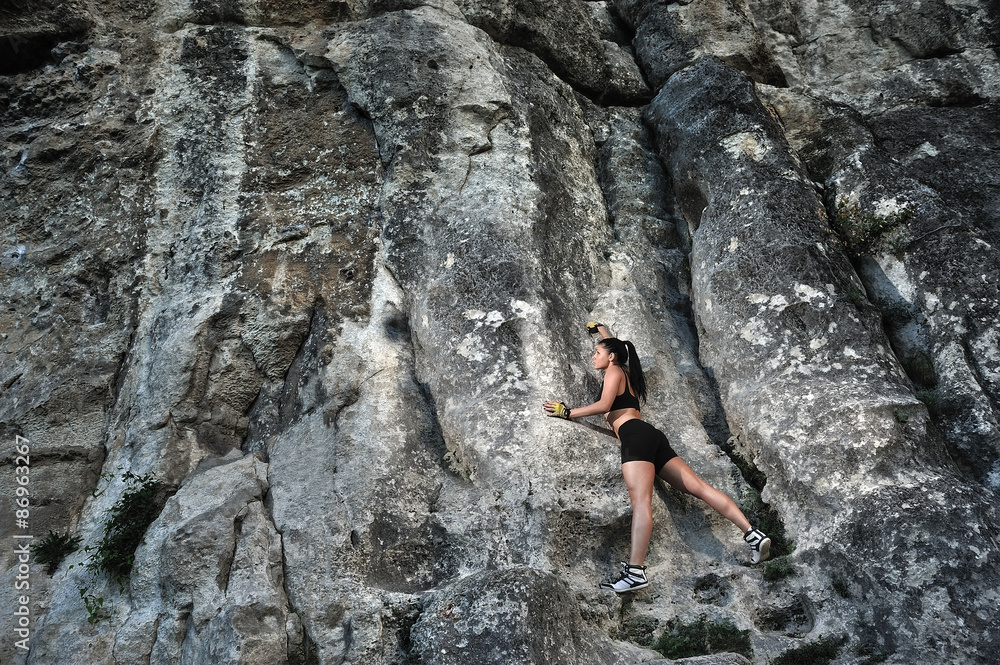 girl climber on the background of rocks