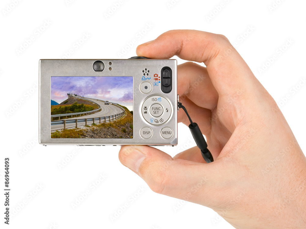 Hand with camera and Norway travel photo Hand with camera and Norway travel photo