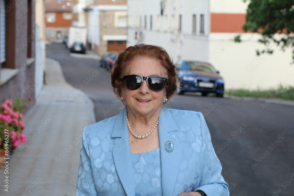 Portrait of a senior woman smiling and wearing sunglasses