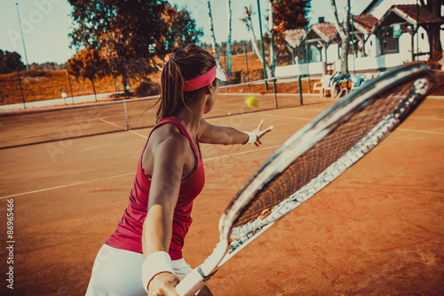 Young woman playing tennis © BalanceFormCreative