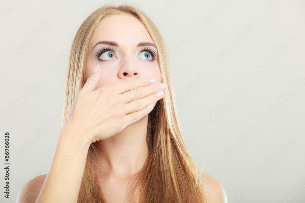 Amazed woman covering her mouth with hand Amazed woman covering her mouth with hand