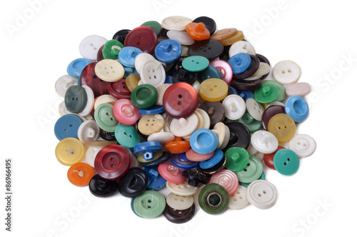 Pile of old colored buttons on white background
