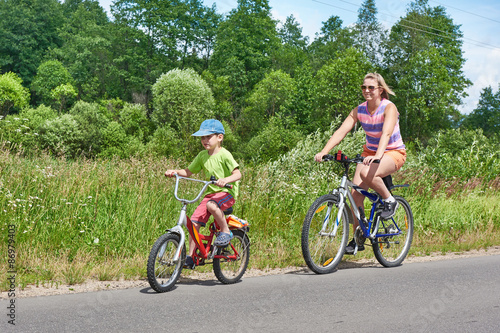 Happy mother and son on bike ride