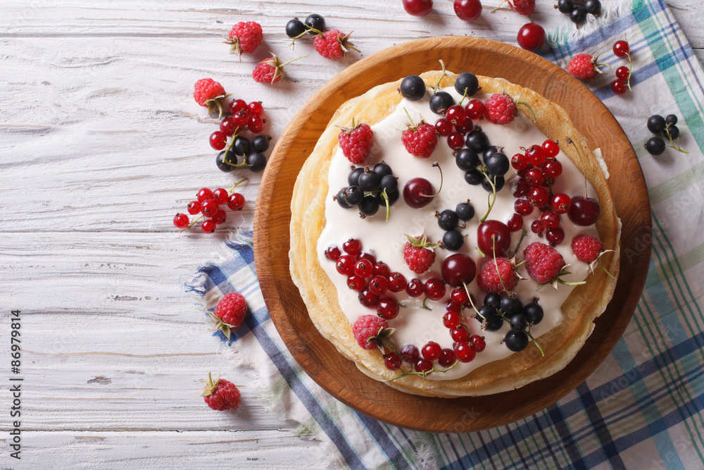 stack of crepes with berries and cream horizontal top view
stack of crepes with berries and cream horizontal top view