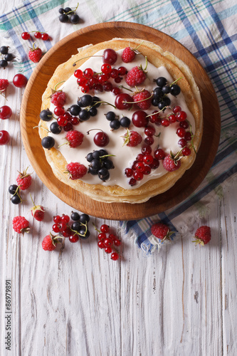 Crepes with berries and cream. vertical top view 