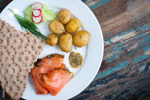 Simple but delicious Scandinavian lunch of gravadlax (smoked salmon) served with new potatoes,crisp bread and salad.
