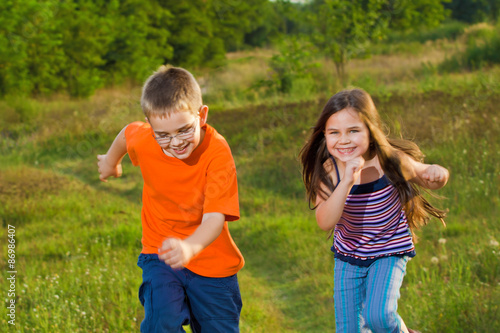 Happy children running at meadow