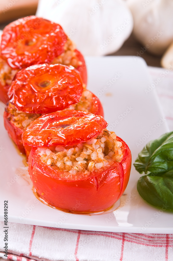 Stuffed tomatoes on a white plate. Stuffed tomatoes on a white plate.