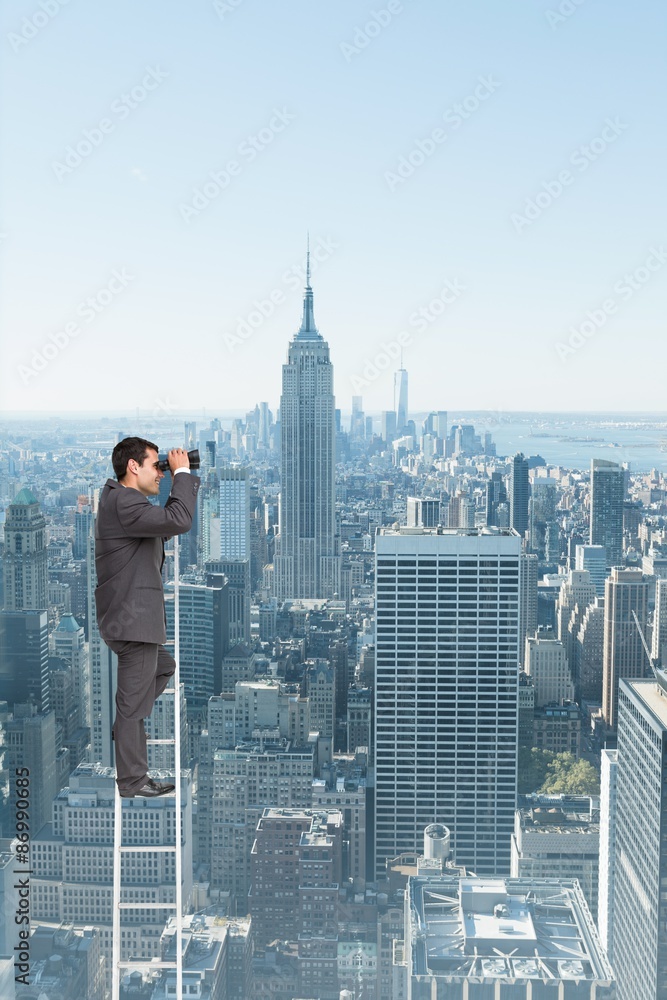 Naklejka premium Composite image of businessman standing on ladder 