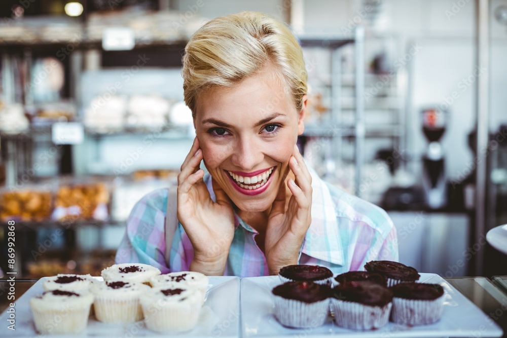Pretty woman looking at cup cakes 