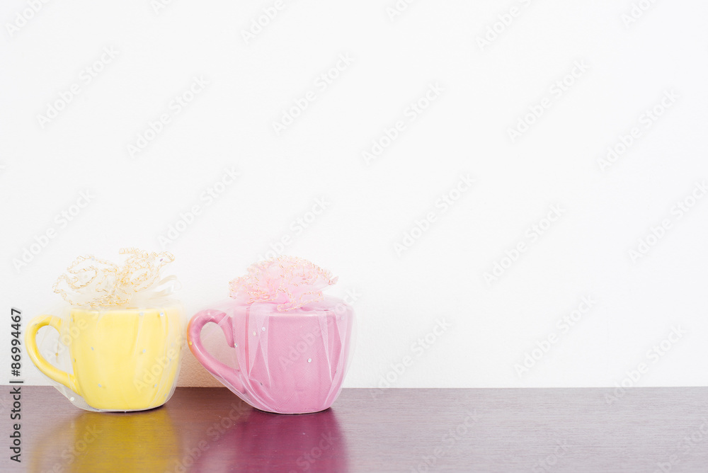 Two mug on wooden table over grunge background. Colorful stack coffee cups on wood board. Vintage retro effect style pictures. Two mug on wooden table over grunge background. Colorful stack coffee cups on wood board. Vintage retro effect style pictures.