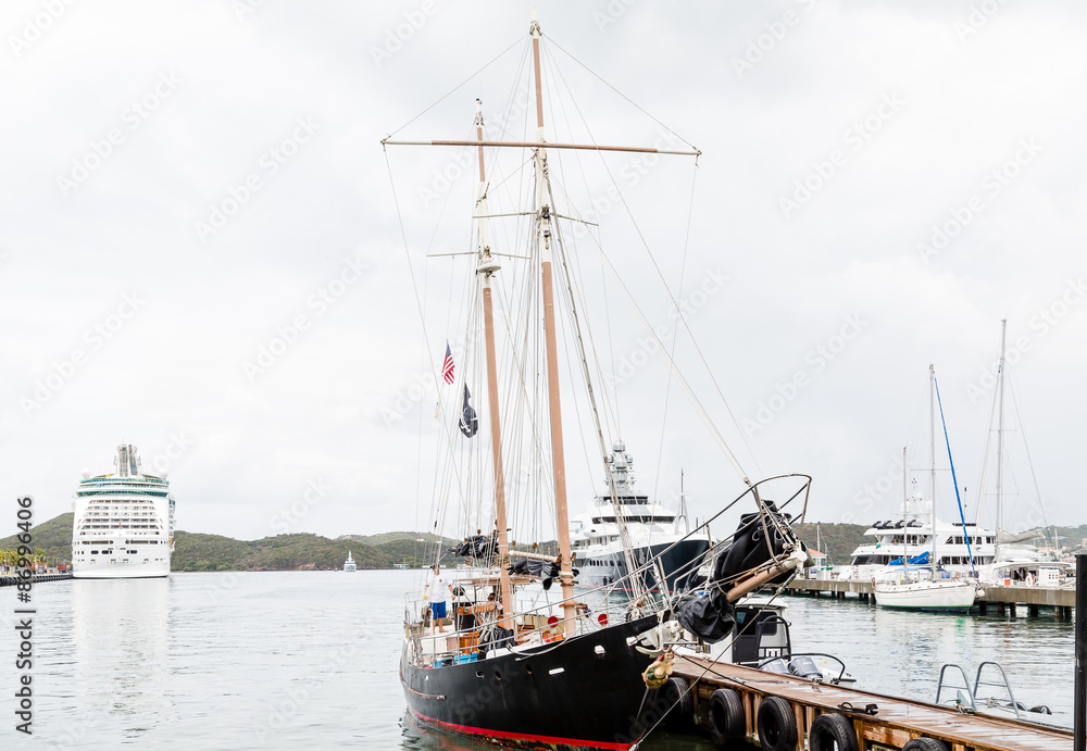 Black Sailboat with Yachts and Cruise Ship