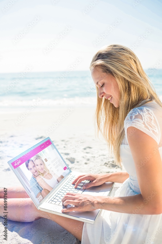 Composite image of  woman using laptop and wearing hat