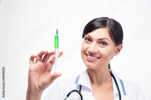 Happy female doctor holding syringe