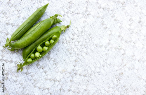 Green peas on the vintage linen background
