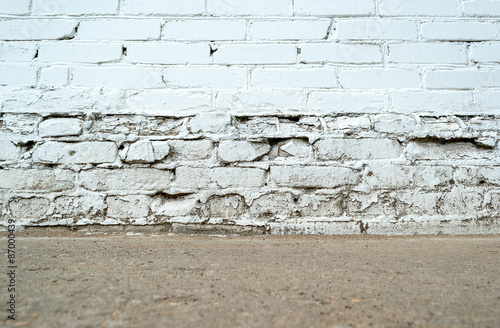Empty grunge brick wall with ground floor