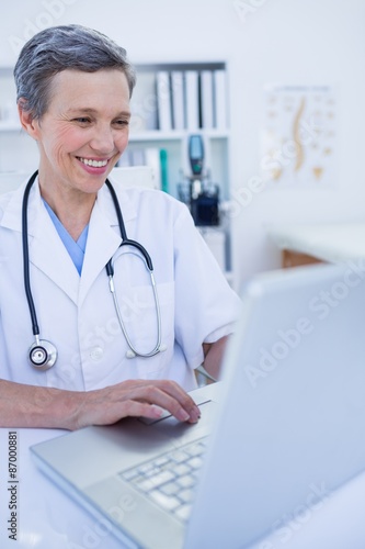 Female doctor using her laptop computer 