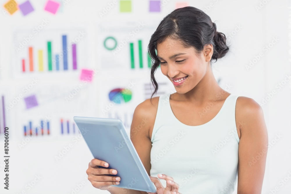 Casual brunette showing tablet computer Casual brunette showing tablet computer