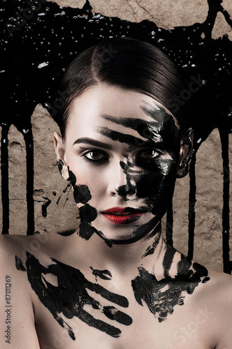 Creative portrait of a girl with paint on his face.