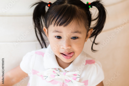 Little girl show her tongue