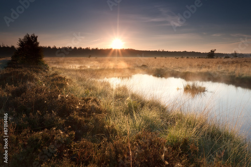 gold misty sunrise on lake