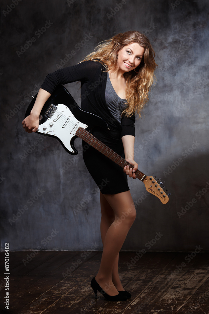 happy woman with a guitar in his hands