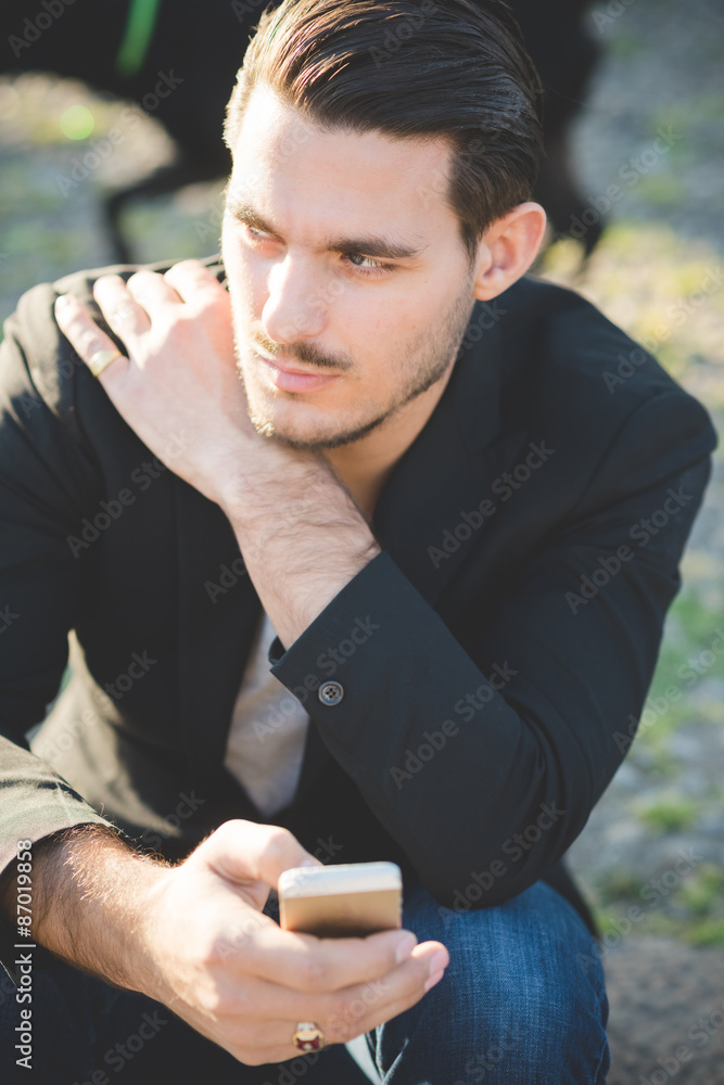 Portrait of a young italian boy using a smartphone Portrait of a young italian boy using a smartphone