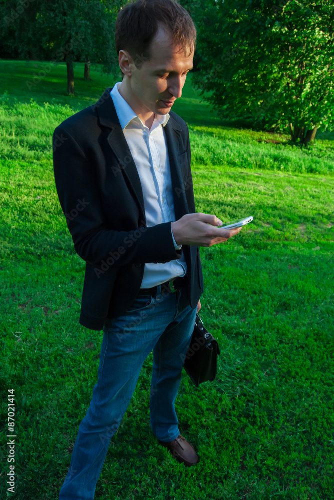 Young man wearing suit qith smartphone Young man wearing suit qith smartphone