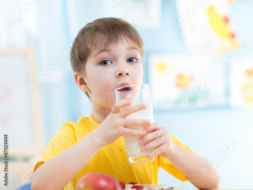 child drinks healthy milk at home