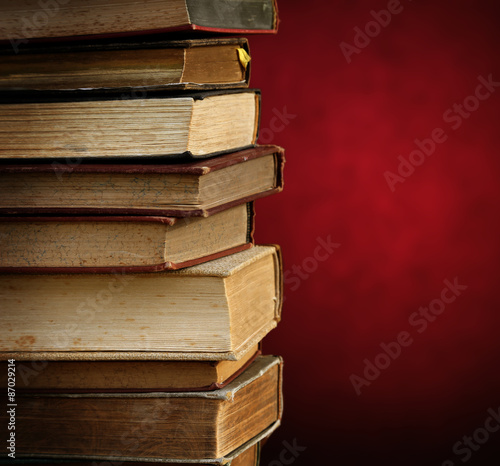 old books on red background.