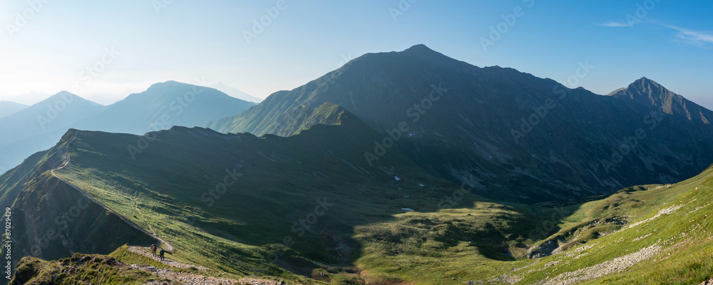 Naklejka premium Panorama of amazing morning summer mountains with hikers