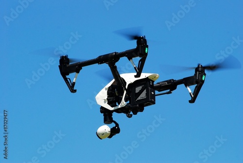 Drone in flight on blue sky background