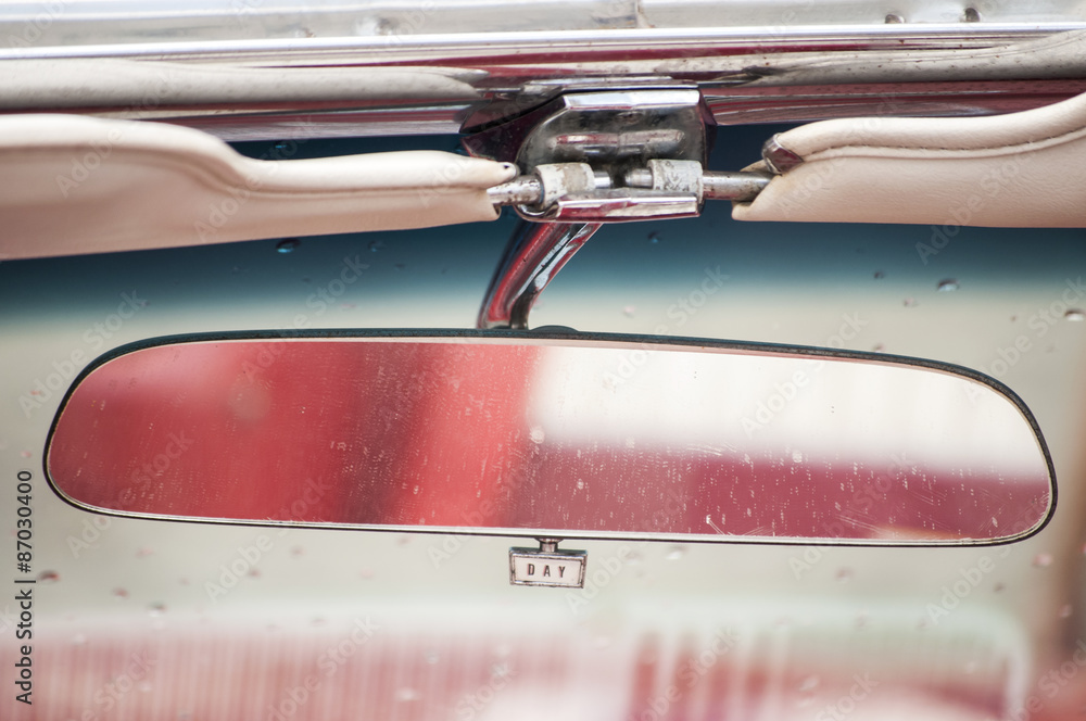 Naklejka premium Rear view mirror closeup in vintage car