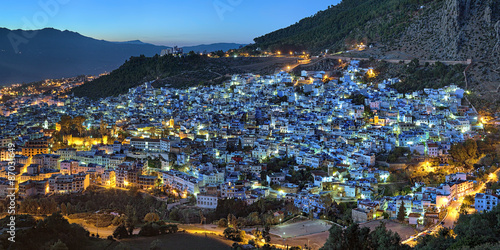 Evening panorama of Chefchaouen medina quarter with buildings painted in blue color from the hill of Jemaa Bouzafar Mosque, Morocco © Mikhail Markovskiy