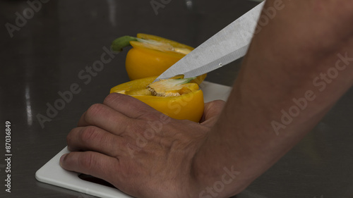 A man clearing a pepper from the seeds