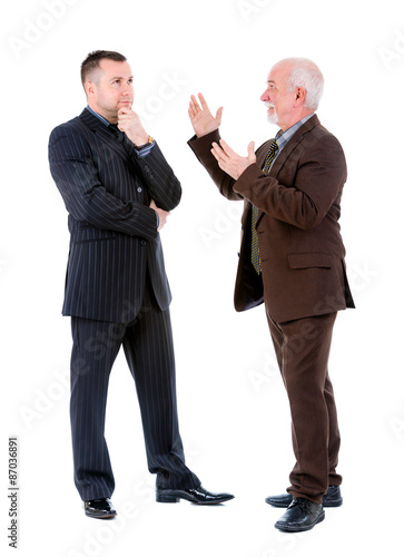 Young and old senior two businessman in suits argue and swear. Isolated on white background, Negative human emotion, facial expression