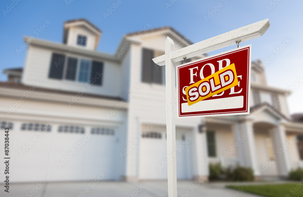 Sold Home For Sale Sign in Front of New House Sold Home For Sale Sign in Front of New House