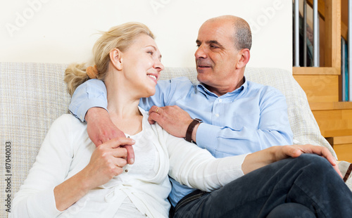 Elderly couple flirting with love and sitting