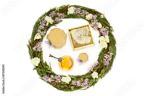 Honey and herbs composition on white background