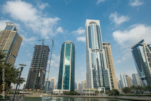 Tall skyscrapers in Dubai near water © Elnur