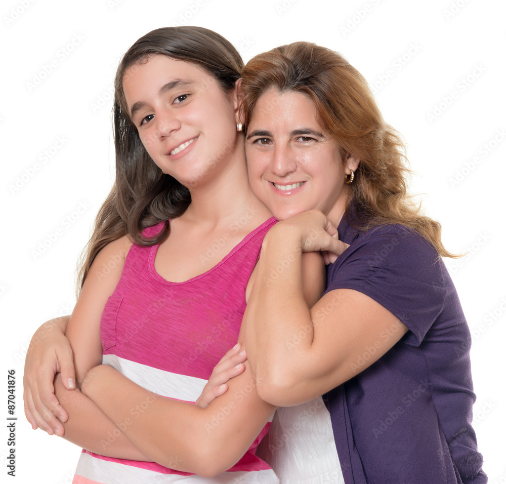 Hispanic mother hugs her teenage daughter isolated on white Hispanic mother hugs her teenage daughter isolated on white