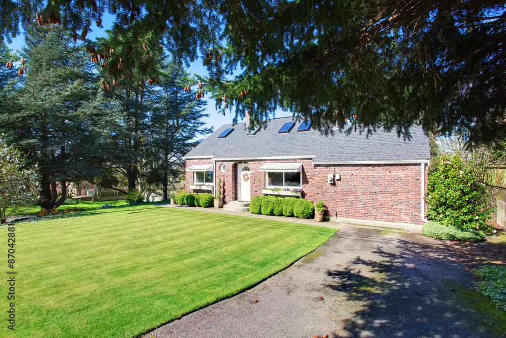 Traditional brick house with very well kept lawn. Traditional brick house with very well kept lawn.